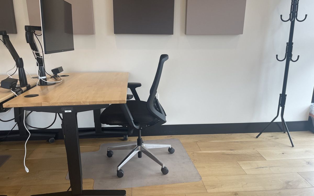 A dedicated desk on the upstairs floor with a 32-inch 4K monitor and task chair