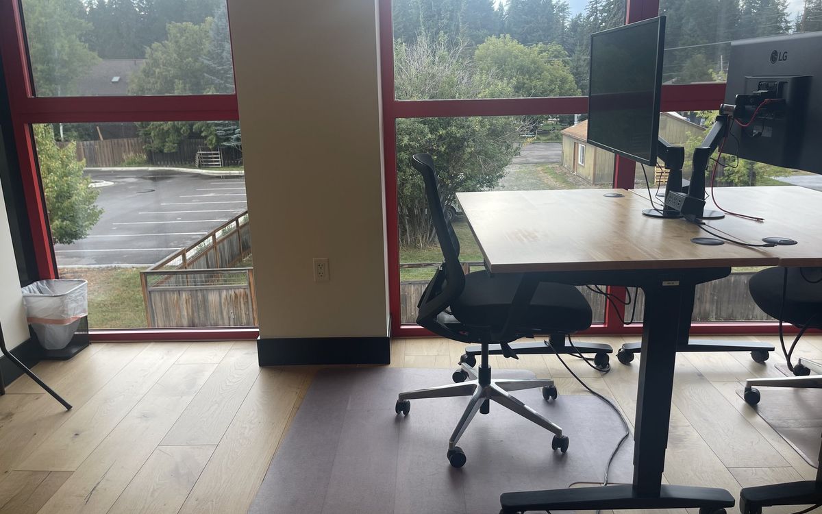 A dedicated desk on the upstairs floor with a 32-inch 4K monitor and task chair