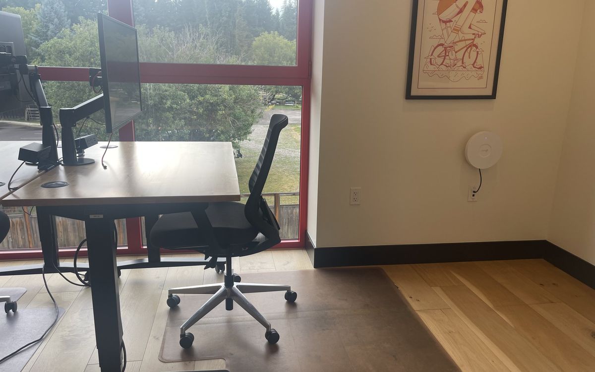 A dedicated desk on the upstairs floor with a 32-inch 4K monitor and task chair