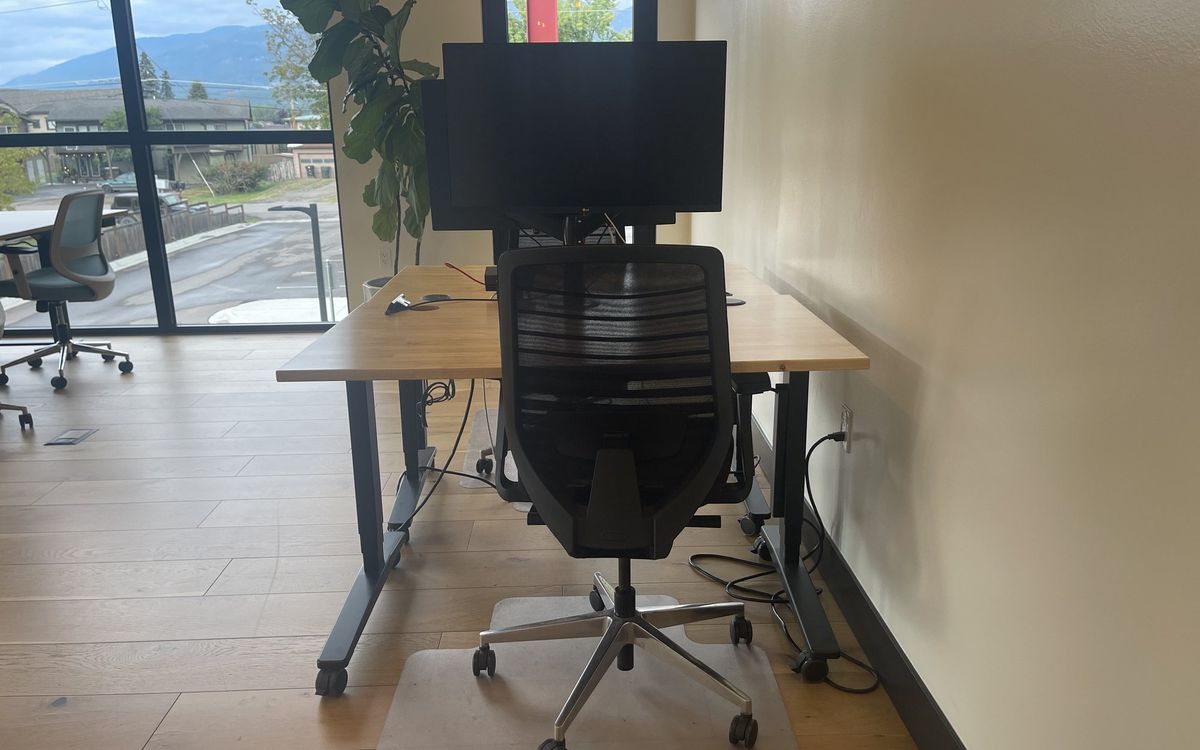 A dedicated desk on the upstairs floor with a 32-inch 4K monitor and task chair