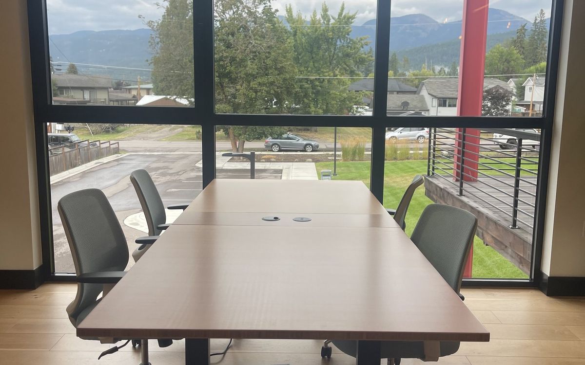 The four upstairs hotdesks pushed into a single block beside the windows