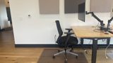 The dedicated desk in context on the upstairs floor, with neighbouring desks beyond
