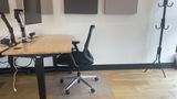 A dedicated desk on the upstairs floor with a 32-inch 4K monitor and task chair