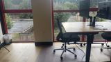 A dedicated desk on the upstairs floor with a 32-inch 4K monitor and task chair