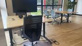 The dedicated desk in context on the upstairs floor, with neighbouring desks beyond