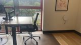 A dedicated desk on the upstairs floor with a 32-inch 4K monitor and task chair
