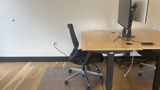 A dedicated desk on the upstairs floor with a 32-inch 4K monitor and task chair