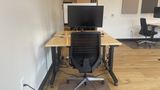 The dedicated desk in context on the upstairs floor, with neighbouring desks beyond