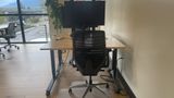 A dedicated desk on the upstairs floor with a 32-inch 4K monitor and task chair