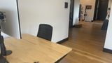 The dedicated desk in context on the upstairs floor, with neighbouring desks beyond