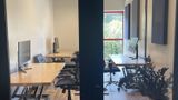 Looking through the glass doors at the desks inside