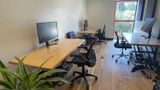 Down the length of the room, past the monitors