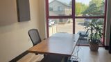 Walnut desk along the red-framed window wall