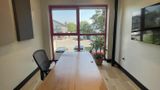 Looking toward the red-framed window across the walnut table