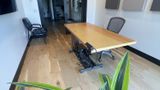 The office from the corner — glass doors and acoustic panels