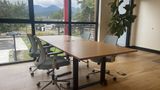 The upstairs hotdesks from across the floor, with the red structural column at the window