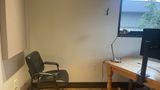 Private Office 10 looking toward the window, with a guest chair beside the desk