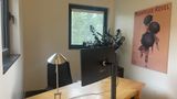 The desk in Private Office 10 with a framed print on the wall