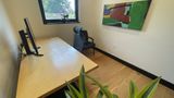 Birch desk running toward the window, artwork on the far wall