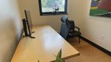 The desk seen from the corner, with the window and canvas behind
