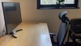 Along the desk surface toward the black-framed window