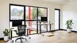 Hotdesk facing floor-to-ceiling windows and a mountain view