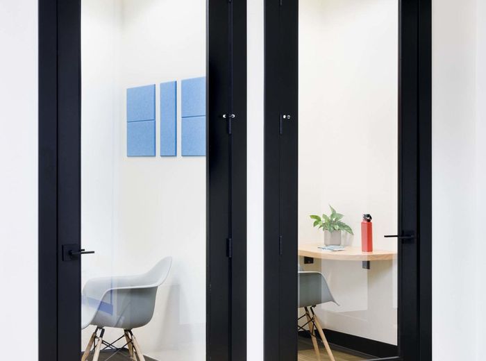 Phone booth with a small desk and chair