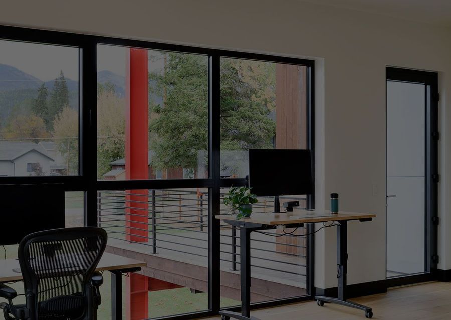Standing desk facing a window with a mountain view