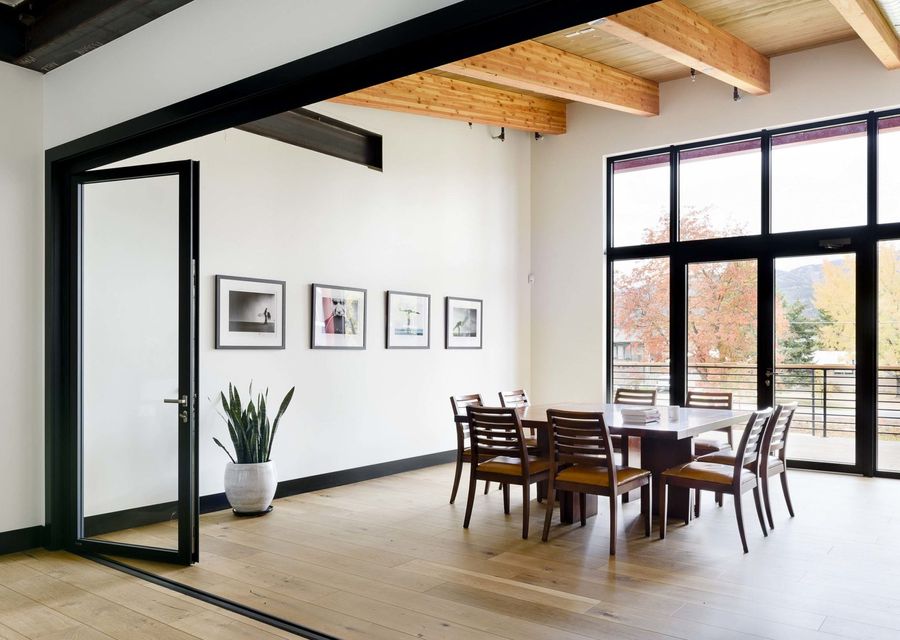 Meeting room with a long wooden table and framed prints