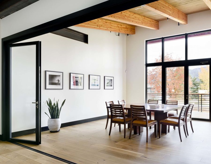 Meeting room with a long wooden table and framed prints